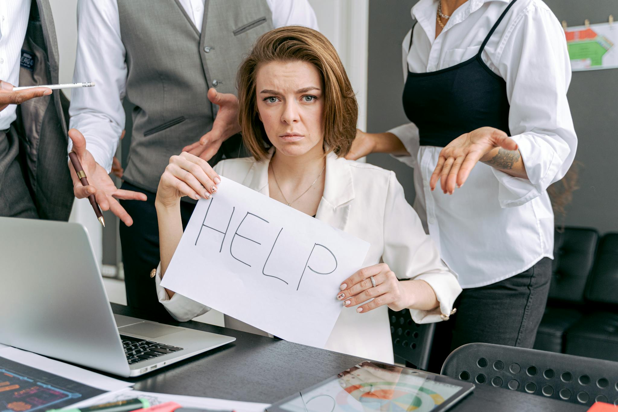 Stressed Office Worker Holding A Help Sign